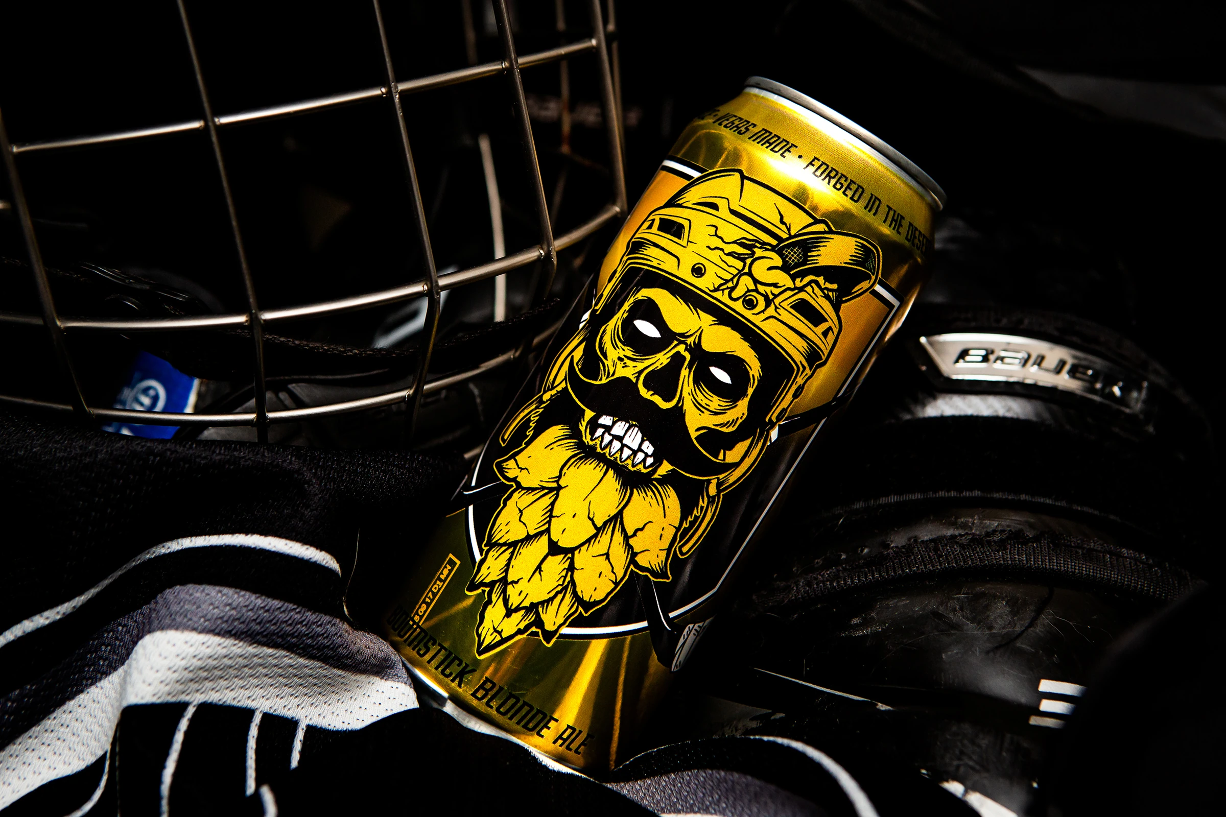 Boomstick Blonde Ale can among hockey gear
